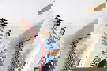 man cleaning air vent