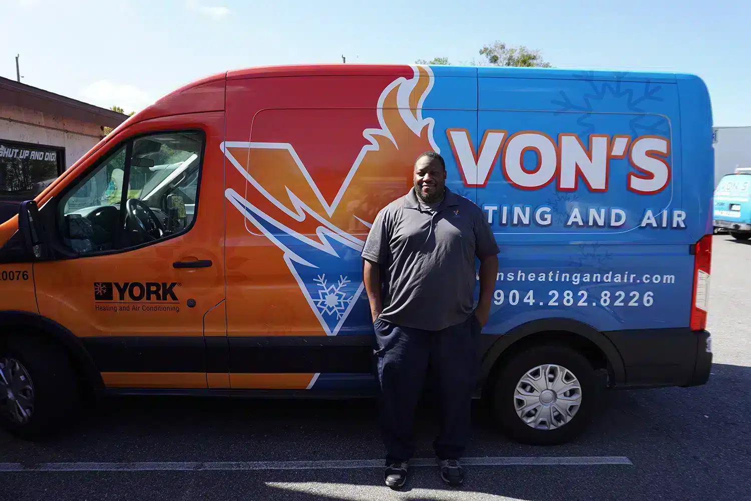 Von's tech in front of heating and air services truck